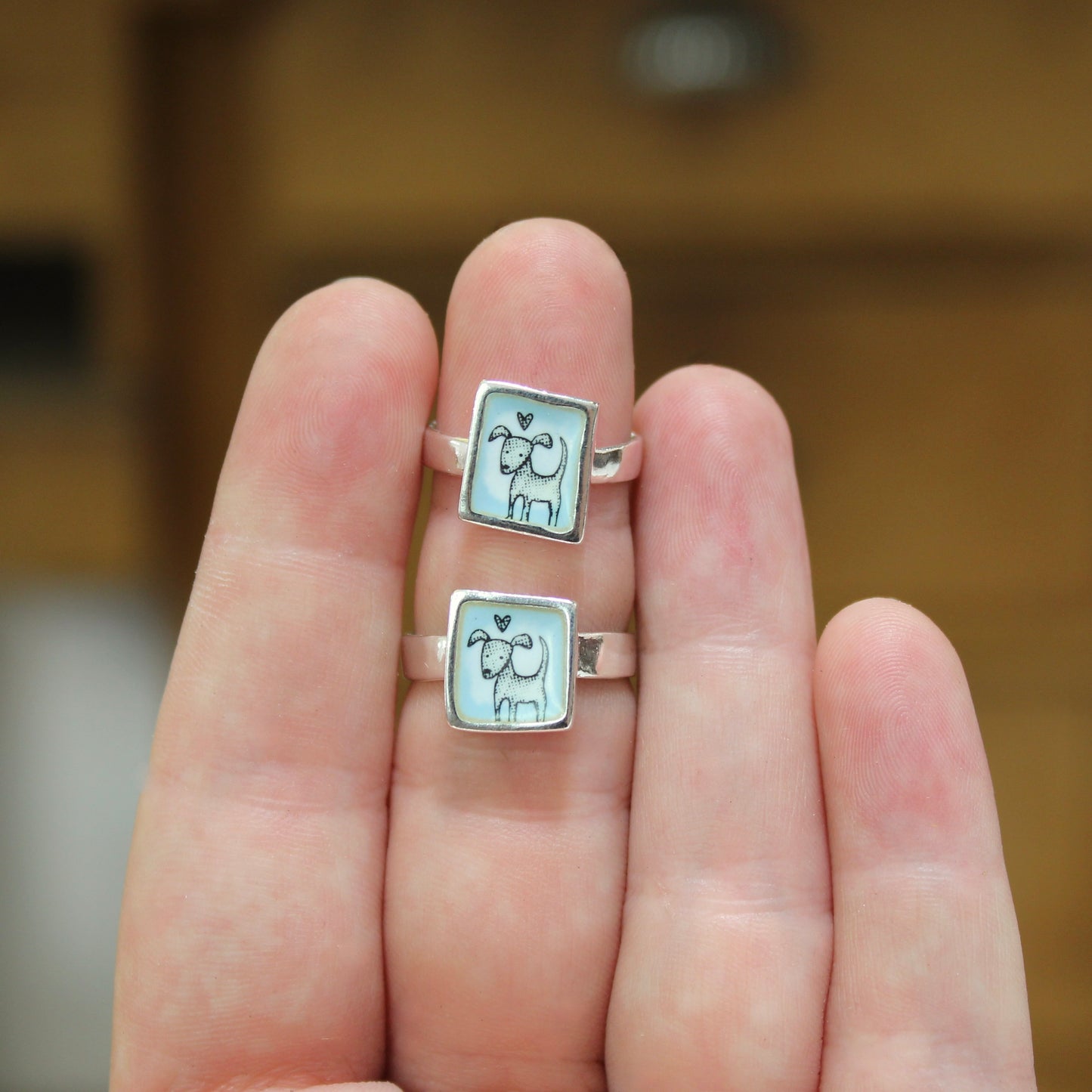 Sterling Silver and Enamel Love Dog Ring on Light Blue