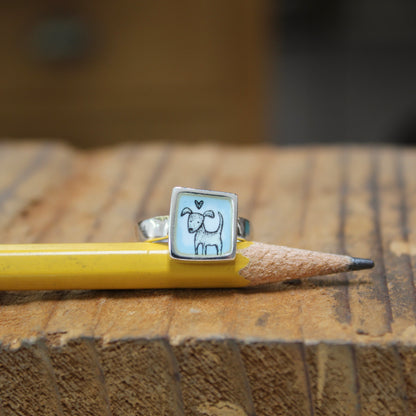 Sterling Silver and Enamel Love Dog Ring on Light Blue