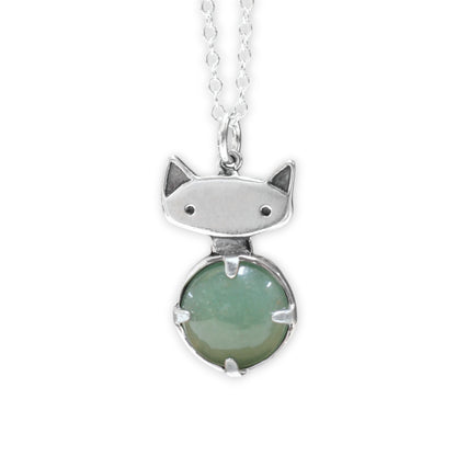 Cat-shaped pendant with a green gemstone on a white background