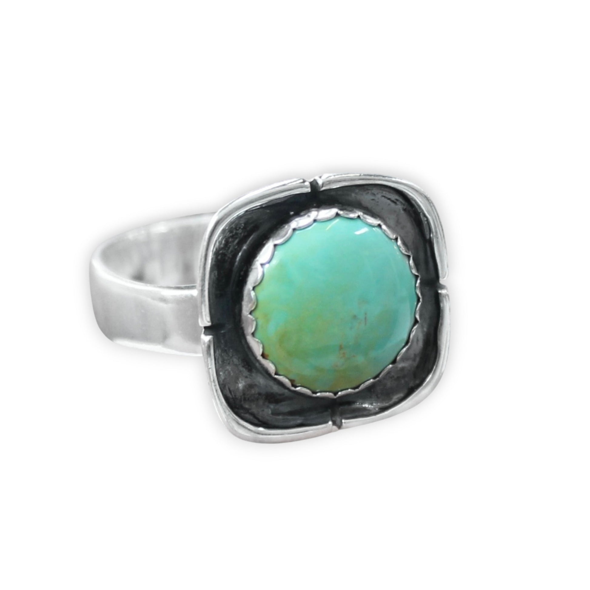 Silver ring with a turquoise stone on a white background