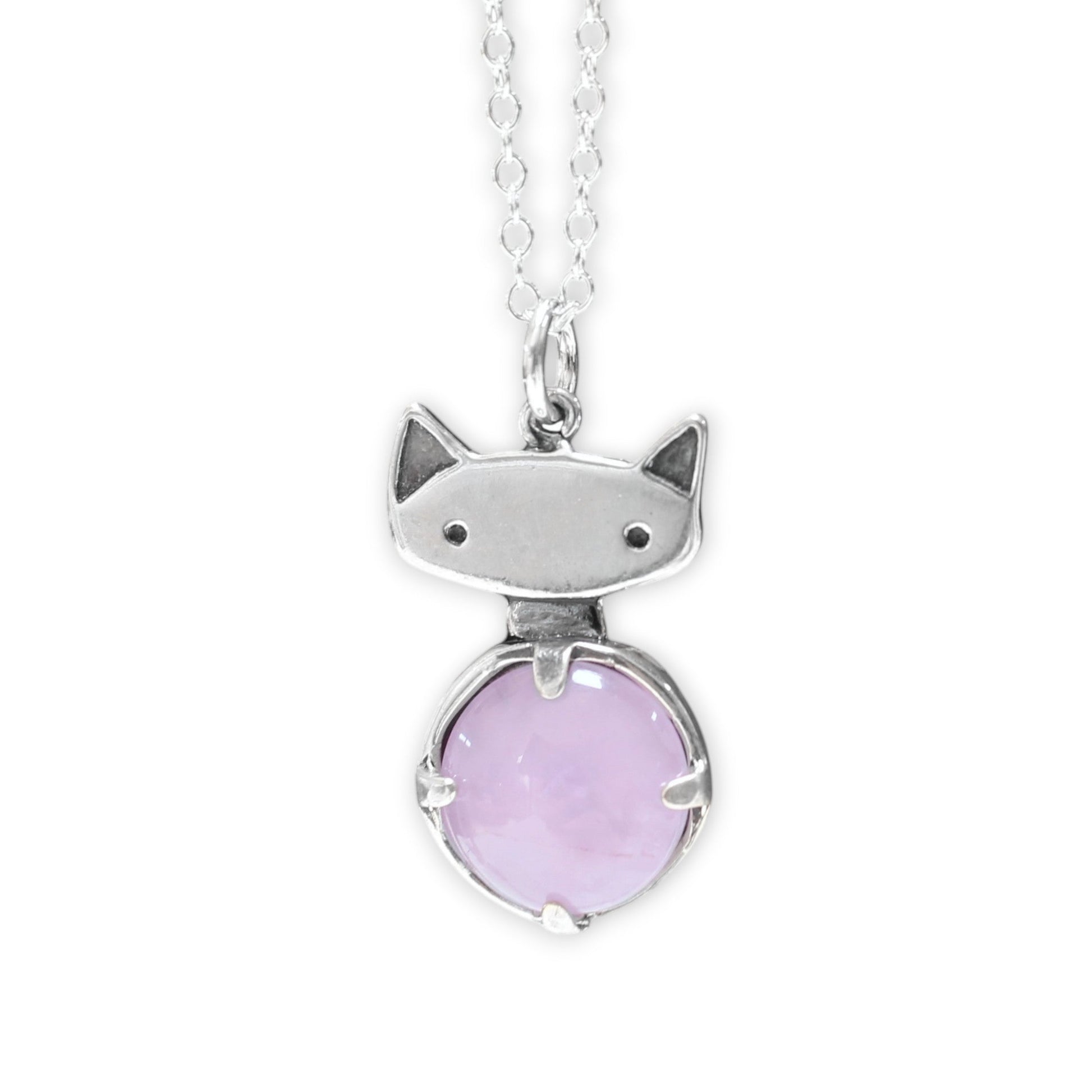 Cat-shaped pendant with a pink gemstone on a white background