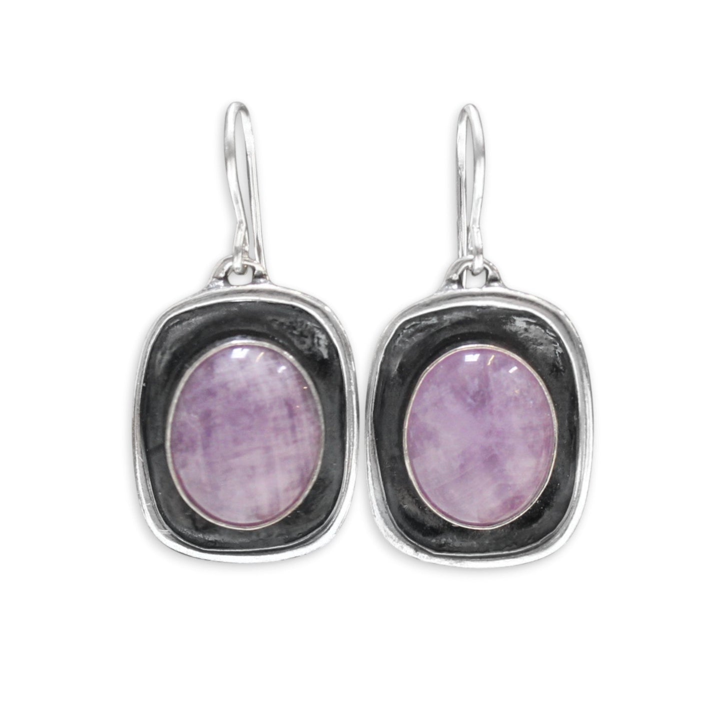 Silver earrings with purple gemstones on a white background