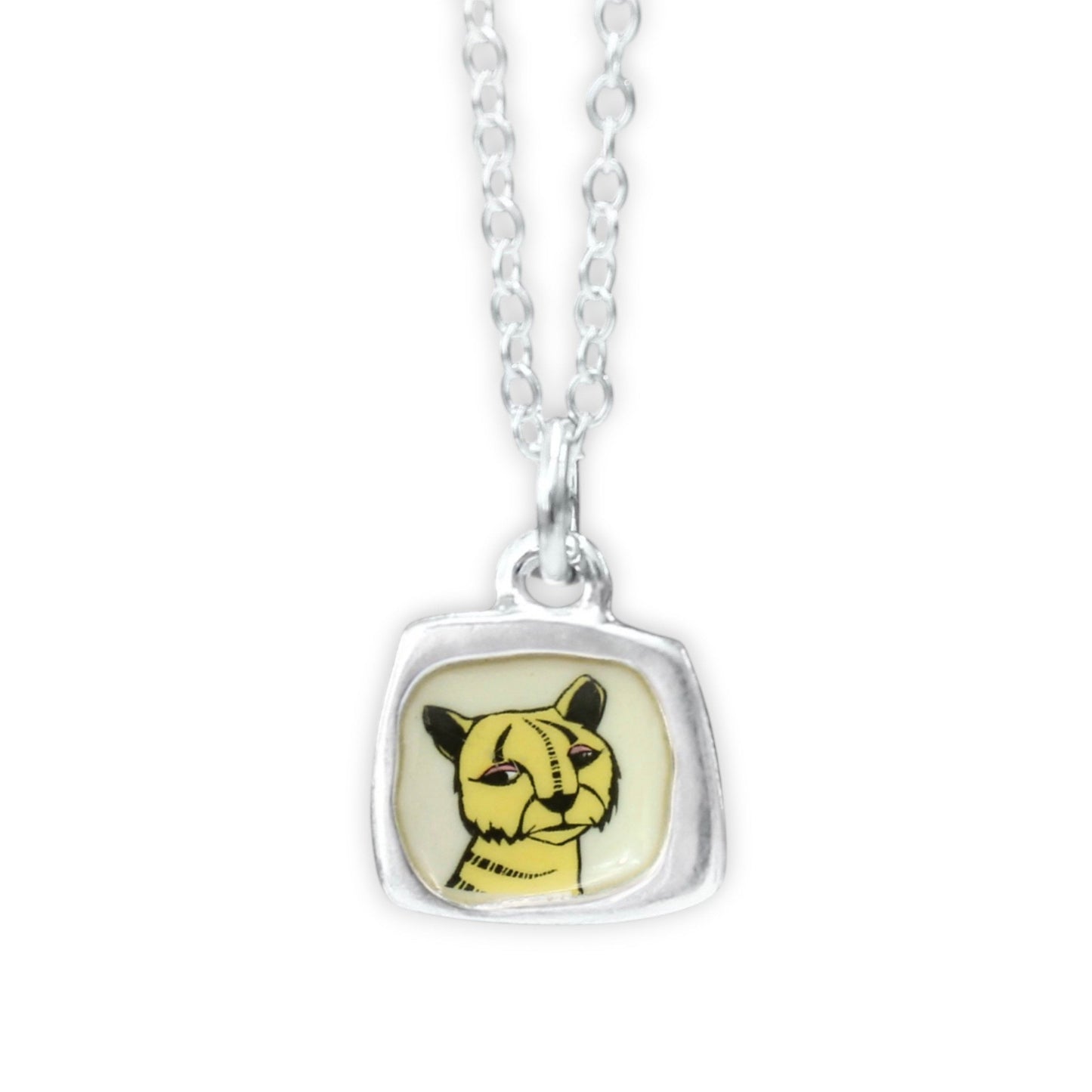 A silver chain necklace with a square bezel pendant featuring a yellow and black cat illustration on a cream background.
