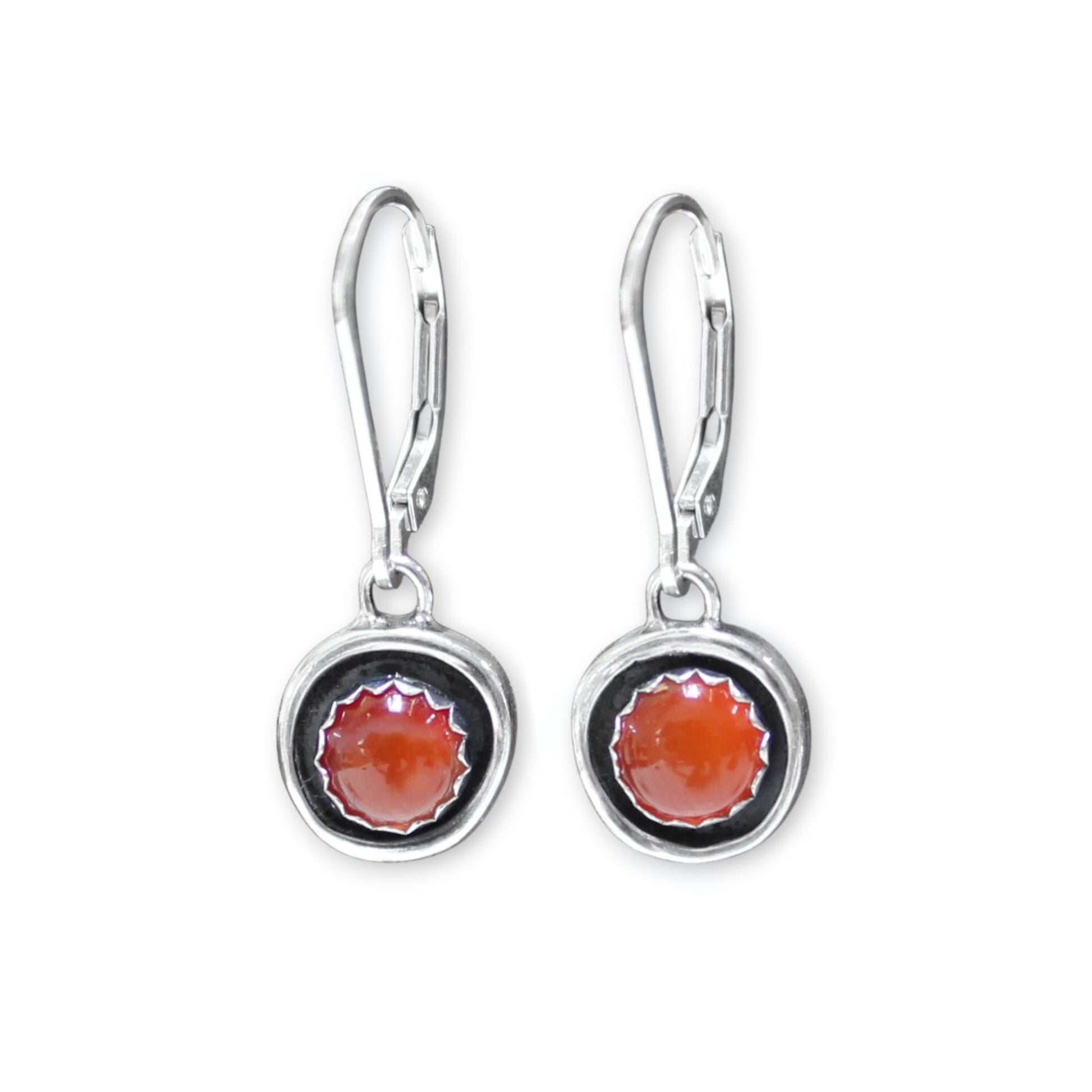 Silver earrings with circular designs on a white background
