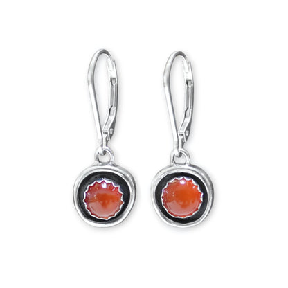 Silver earrings with circular designs on a white background